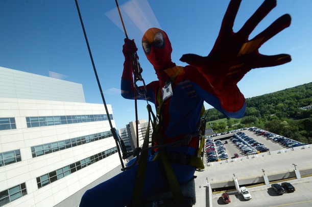 Spiderman is seen hanging from a rope outside of an eighth-floor window at C.S. Mott Children's Hospital on Monday, June, 3, 2013. Melanie Maxwell I AnnArbor.com